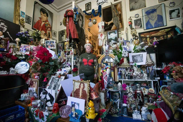 Marie-Rose Trogh, 71 years old, is surrounded by her collection of Elvis Presley memorabilia in Brussels, Belgium, 11 April 2017. Trogh has been collecting Elvis Presley items since 1977, the year the US singer and actor died. She stopped counting her collection after 10,000 pieces. (Photo by Stephanie Lecocq/EPA)