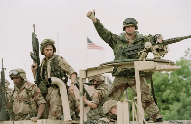 In a December 10, 1992 file photo, a U.S. Marine gives the thumbs up as a truck load of troops arrive at the reopened U.S. Embassy in Mogadishu, Somalia.  According to the U.S. Africa Command on Friday April 14, 2017,  the U.S. military is sending dozens of regular troops to Somalia to train Somali soldiers in the largest such deployment to the Horn of Africa country in roughly two decades. (Photo by Denis Pauqin/AP Photo)