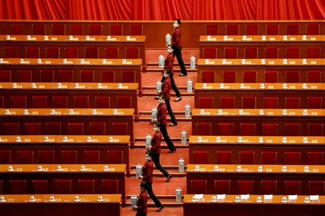 Attendants serve tea before the opening session of the Chinese People's Political Consultative Conference (CPPCC) at the Great Hall of the People in Beijing, China on March 4, 2022. (Photo by Carlos Garcia Rawlins/Reuters)
