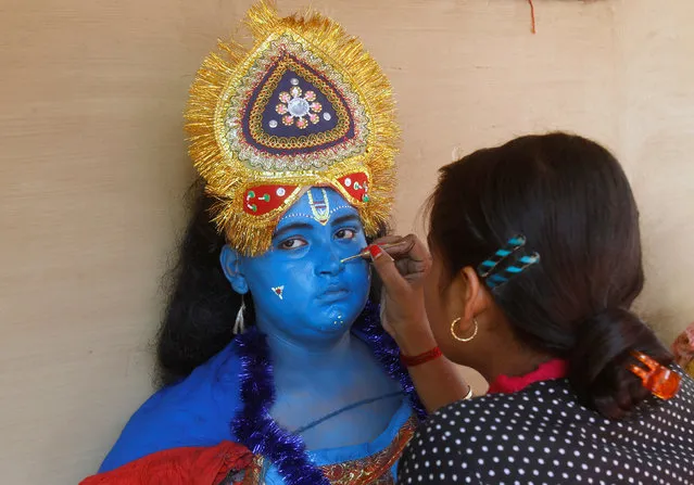 A Hindu boy has his face painted before taking part in a ritual as part of the annual Shiva Gajan religious festival on the outskirts of Agartala, April 13, 2017. (Photo by Jayanta Dey/Reuters)