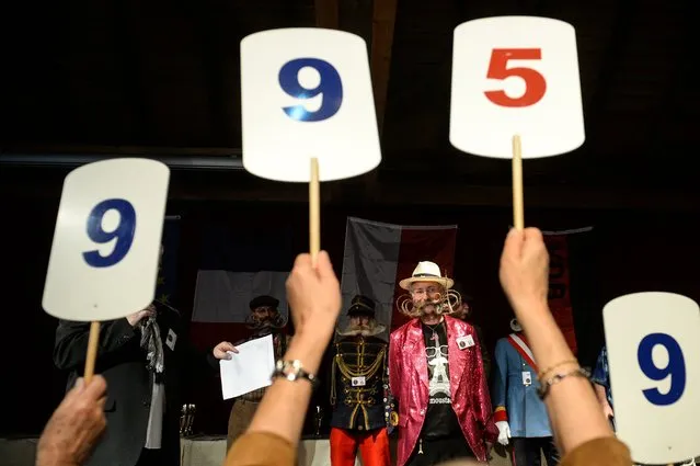 Competitors receive scores during a beard and moustache competition at the Ecomusee d'Alsace in Ungersheim on April 30, 2017. (Photo by Sebastien Bozon/AFP Photo)