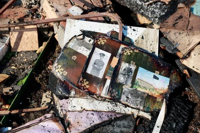 Pictures lie amidst the rubble of former teacher Natalia's house which was was hit in a military strike, amid Russia's invasion of Ukraine, in Kyiv, Ukraine on March 23, 2022. (Photo by Serhii Nuzhnenko/Reuters)