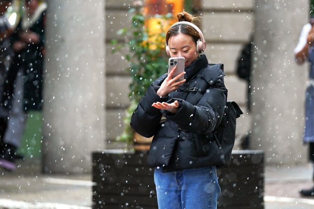 A person on her mobile phone Covent Garden in London on Monday, January 8, 2024. Sleet and snow showers have been forecast for parts of the country on Monday as some regions are still trying to grapple with flooding following intense rainfall. (Photo by Lucy North/PA Images via Getty Images)