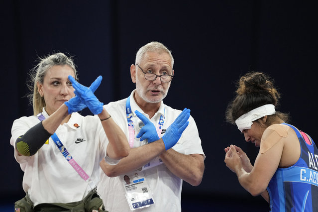 Official doctors prohibit Algeria's Chaimaa Fouzia Aouissi to fight in the round of 16 of the women's freestyle 57kg wrestling match against Nigeria's Odunayo Folasade Adekuoroye, at Champ-de-Mars Arena, during the 2024 Summer Olympics, Thursday, August 8, 2024, in Paris, France. (Photo by Eugene Hoshiko/AP Photo)