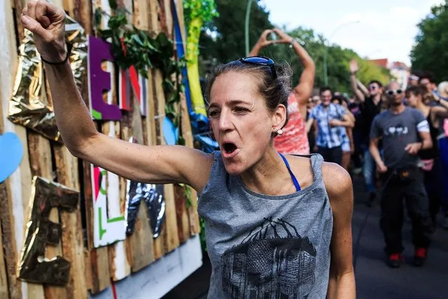 A woman  dances during the “Zug der Liebe” (The Love Train) techno and electronic music parade on July 25, 2015 in Berlin, Germany. (Photo by Carsten Koall/Getty Images)