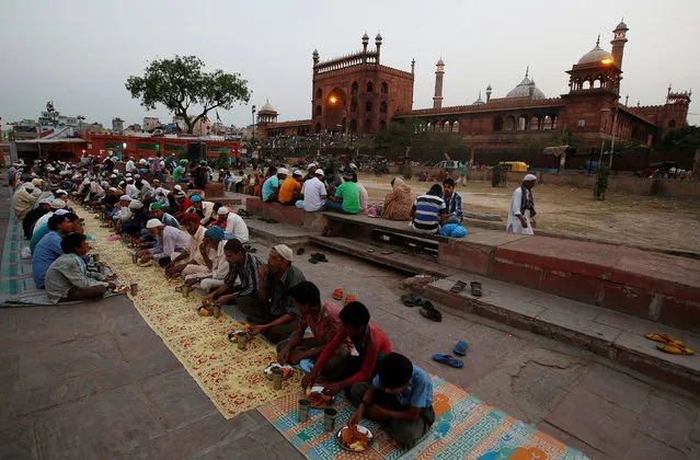 Muslims eat their iftar (breaking of fast) meal during the holy month of Ramadan at a mosque in the old quarters of Delhi, India, June 8, 2016. (Photo by Adnan Abidi/Reuters)