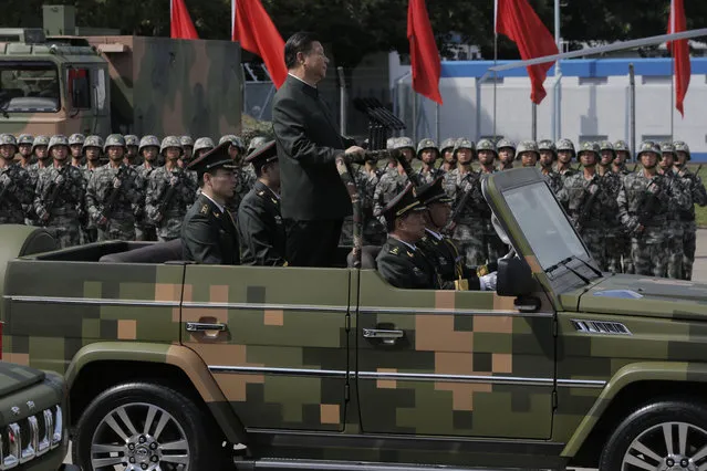Chinese President Xi Jinping inspects the People's Liberation Army's Hong Kong Garrison at the Shek Kong Barracks in Hong Kong, Friday, June 30, 2017. Xi landed in Hong Kong Thursday to mark the 20th anniversary of Beijing taking control of the former British colony, accompanied by a formidable layer of security as authorities showed little patience for pro-democracy protests. (Photo by Kin Cheung/AP Photo)