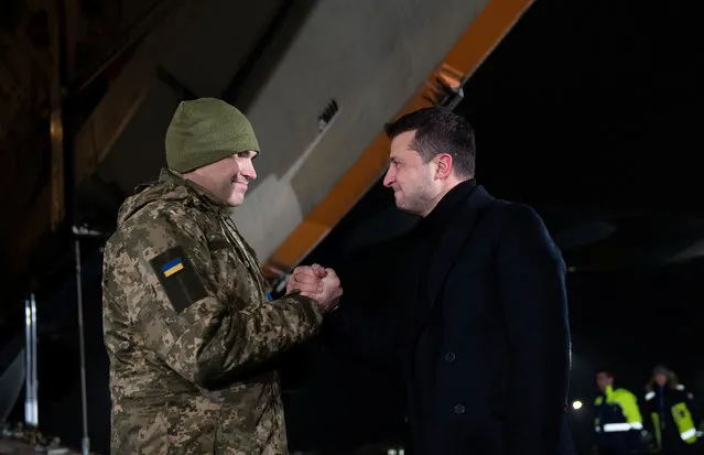 Ukraine's President Volodymyr Zelenskiy welcomes a Ukrainian serviceman, who was exchanged during a prisoners of war (POWs) swap with the separatist self-proclaimed republics, at the Boryspil International Airport outside Kiev, Ukraine on December 29, 2019. (Photo by Ukrainian Presidential Press Service/Handout via Reuters)