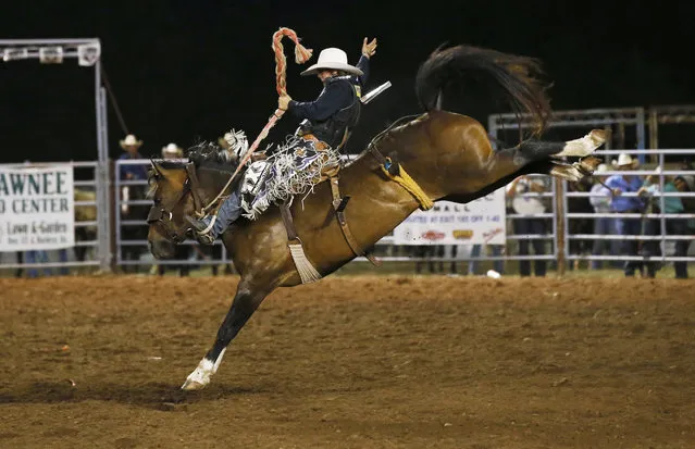 Stetson Wright of Milford, Utah, competes in the saddle bronc championship at the International Finals Youth Rodeo in Shawnee, Okla., Friday, July 14, 2017. (Photo by Sue Ogrocki/AP Photo)