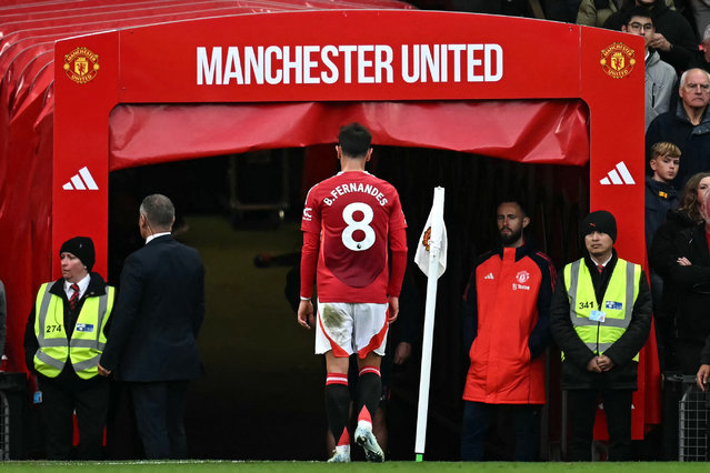 Manchester United's Portuguese midfielder #08 Bruno Fernandes leaves the pitch room after being shown a straight red card by English referee Chris Kavanagh during the English Premier League football match between Manchester United and Tottenham Hotspur at Old Trafford in Manchester, north west England, on September 29, 2024. (Photo by Paul Ellis/AFP Photo)