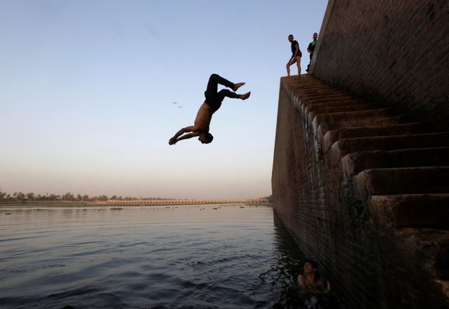 Boys jump into the Nile River amid a heatwave in El Qanater El Khairiyah, Al Qalyubia Governorate, Egypt, on June 14, 2024. (Photo by Mohamed Abd El Ghany/Reuters)