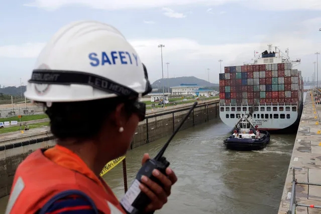 A worker talks on a walkie talkie as cargo ship named Cosco Houston, navigates through Cocoli locks during a test of the new set of locks of the Panama Canal expansion project on the Pacific side in Cocoli, on the outskirts of Panama City, Panama June 23, 2016. (Photo by Carlos Jasso/Reuters)