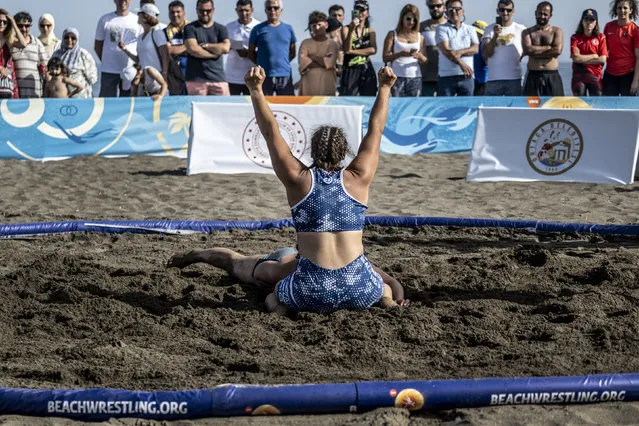 In this handout image provided by United World Wrestling, Stefania Zacheila of Greece reacts during her match against Aysegul Ozbege (obscured) of Turkey during the final day of the first stop of the UWW Beach Wrestling World Series on May 29, 2022 in Sarigerme, Turkey. (Photo by Dean Treml/UWW via Getty Images)