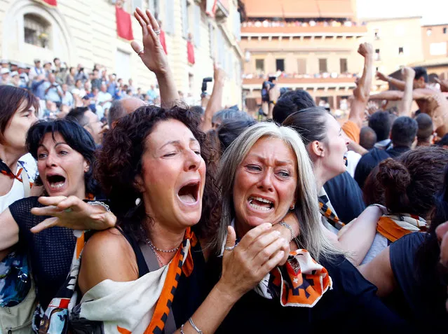 “Lupa” or (Wolf) parish supporters celebrates after winning the Palio horse race in Siena, Italy, July 2, 2016. (Photo by Stefano Rellandini/Reuters)