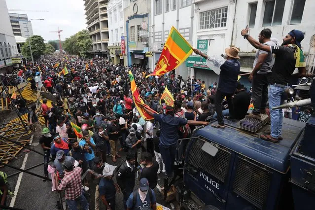 People attend an anti government protest rally, calling for the resignation of the president over the alleged failure to address the economic crisis, near the President's house in Colombo, Sri Lanka, 09 July 2022. Protests have been rocking the country for over three months, calling for the resignation of the president and prime minister over the alleged failure to address the economic crisis. Sri Lanka faces its worst-ever economic crisis in decades due to the lack of foreign reserves, resulting in severe shortages in food, fuel, medicine, and imported goods. (Photo by Chamila Karunarathne/EPA/EFE)