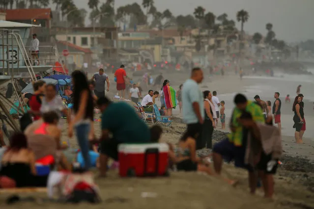 Beachgoers and tourists are pictured on the beach in Oceanside, California U.S. August 2, 2017. (Photo by Mike Blake/Reuters)