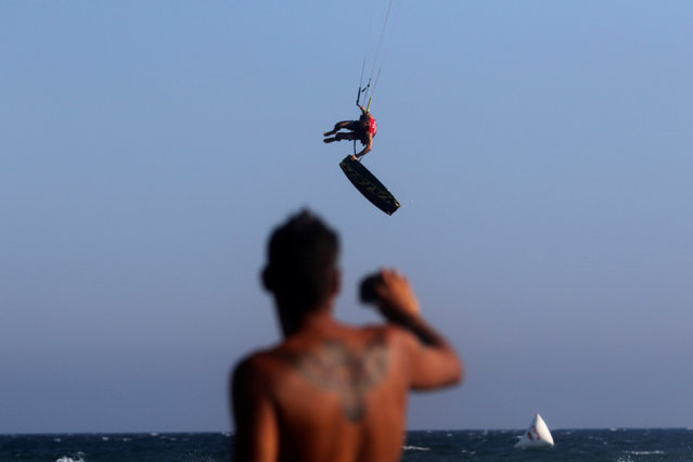 A kite surfer takes to the air during Cyprus kite surfing championship “King of Kite” near Mazotos village, Cyprus July 16, 2016. (Photo by Yiannis Kourtoglou/Reuters)