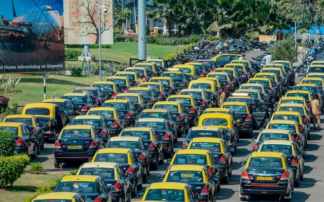 A general view shows queues of prepaid taxis parked, due to national and international travel restrictions and concerns over the spread of the COVID-19 coronavirus, at Chennai International Airport in Chennai on March 19, 2020. (Photo by Arun Sankar/AFP Photo)