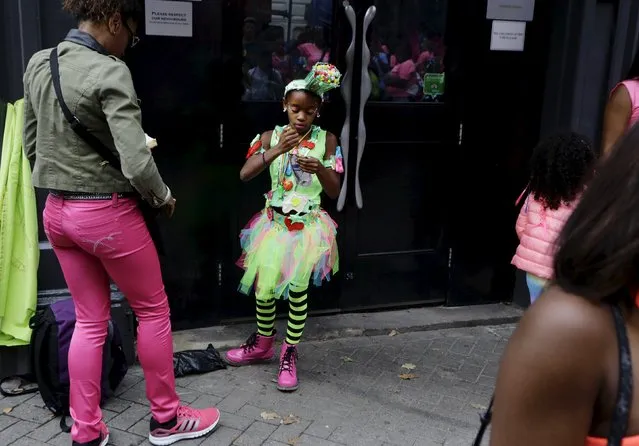 A girl in costume gets ready before the start of the Notting Hill Carnival in London, Britain, August 30, 2015. (Photo by Kevin Coombs/Reuters)
