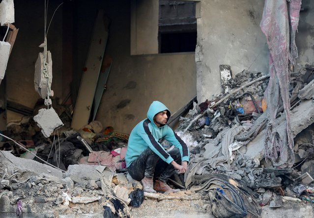 A Palestinian sits at the site of an Israeli strike, amid the Israel-Hamas conflict, at the Nuseirat refugee camp in the central Gaza Strip, on December 13, 2024. (Photo by Ramadan Abed/Reuters)