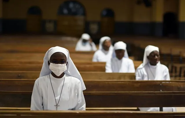 Nuns attend the Last Supper Mass in a nearly empty cathedral amid an outbreak of the coronavirus disease (COVID-19), in Ouagadougou, Burkina Faso on April 9, 2020. (Photo by Anne Mimault/Reuters)