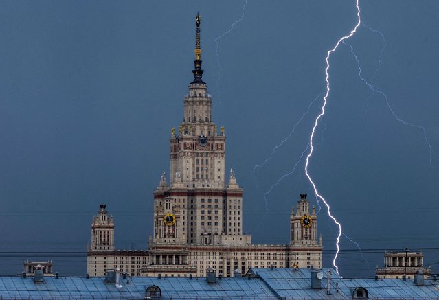 A bolt strikes near Moscow State University building during a thunderstorm in Moscow, Russia on July 5, 2022. (Photo by Maxim Shemetov/Reuters)
