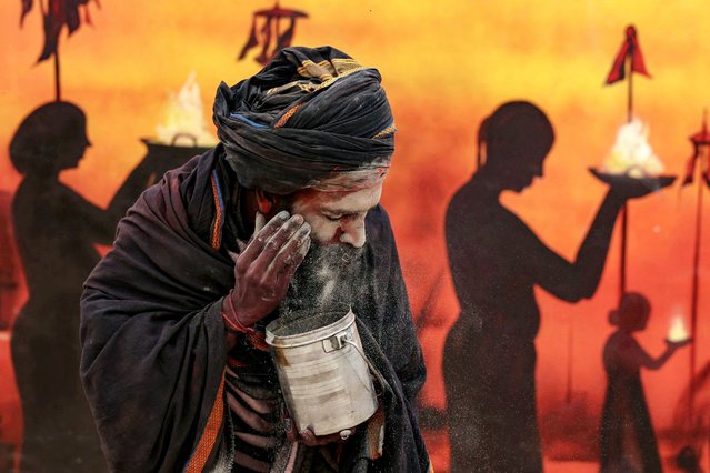 A Sadhu, or a Hindu holy man, applies ash on his face at the revamped Dashashwamedh Ghat on the banks of the river Ganges, ahead of the Maha Kumbh Mela festival in Prayagraj on December 31, 2024. (Photo by Niharika Kulkarni/AFP Photo)