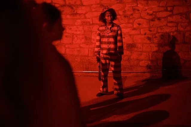 Ashley Mazyck, 26, awaits the next photo opportunity with visitors at “Terror Behind the Walls” haunted house on October 24, 2017 in Philadelphia, Pennsylvania. The haunted house covers 11 acres of the Eastern State Penitentiary, which operated from 1829-1971 and imprisoned famous criminals like Al Capone.  In its 27th year, the Halloween fixture hires nearly 300 seasonal actors and staff for 32 nights of tours, with ticket sales generating 50% of the U.S. National Historic Landmark's annual revenue. (Photo by Mark Makela/Getty Images)
