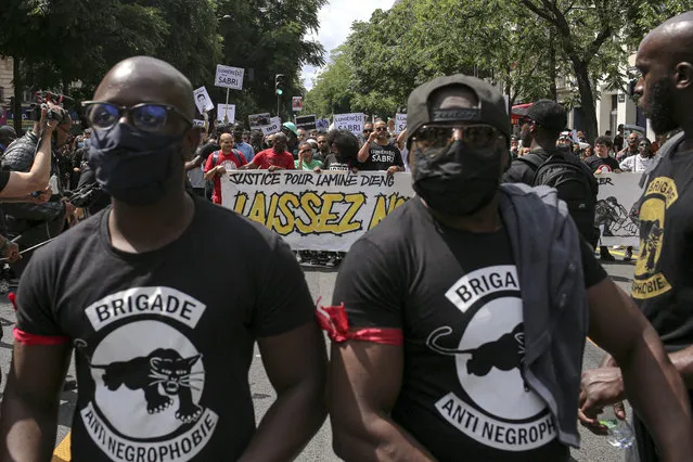 People march during a protest in Paris, Saturday, June 20, 2020. Multiple protests are taking place in France on Saturday against police brutality and racial injustice, amid weeks of global anger unleashed by George Floyd's death in the US. Banner reads “Let us breathe”. (Photo by Rafael Yaghobzadeh/AP Photo)