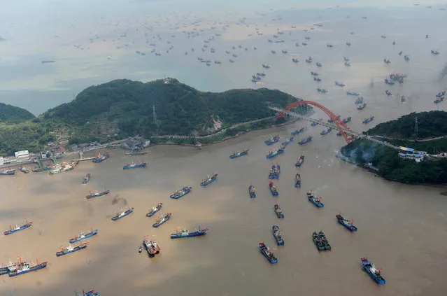Boats set out from a port as the seasonal fishing ban ends in Ningbo, Zhejiang province, China, September 16, 2015. (Photo by Reuters/China Daily)