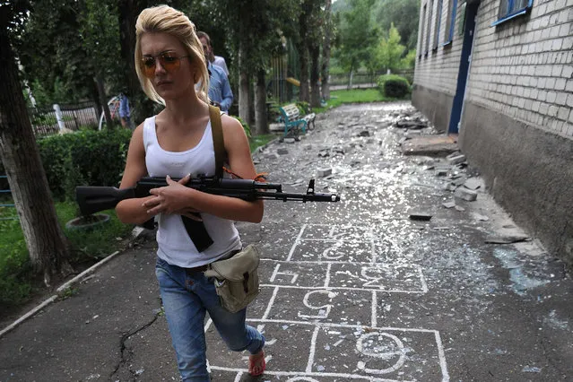 Pro-Russian militants patrol in a kindergarten after bombardments carried out by Ukrainian armed forces  in Petrovsky 25 kilometres west of Donetsk, on July 15, 2014. (Photo by Dominique Faget/AFP Photo)