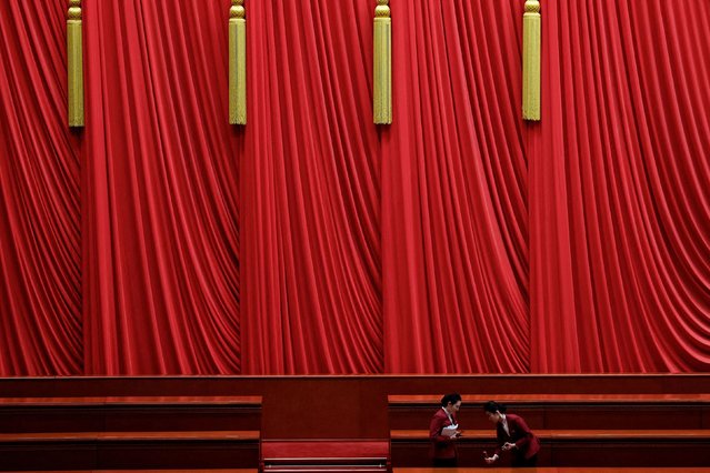 Staff members prepare a table before the start of the second plenary session of the National People's Congress (NPC), at the Great Hall of the People in Beijing, China on March 8, 2025. (Photo by Tingshu Wang/Reuters)