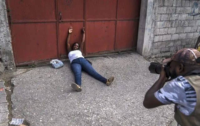 A relative of journalist Romelo Vilsaint grieves after learning that he was fatally shot outside a police station, in Port-au-Prince, Haiti, Sunday, October 30, 2022. (Photo by Ramon Espinosa/AP Photo)