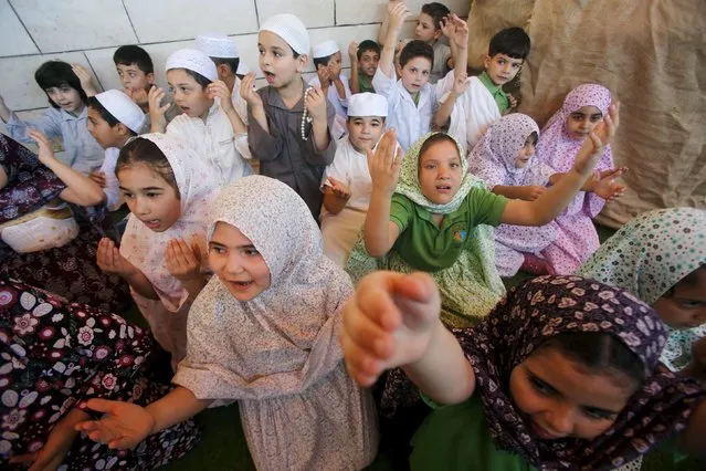 Palestinian children take part in a re-enactment of the annual haj pilgrimage to Mecca, at their school in the West Bank city of Nablus September 22, 2015. (Photo by Abed Omar Qusini/Reuters)