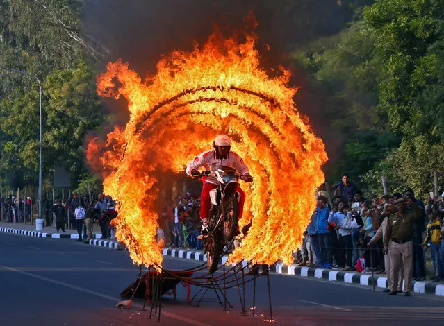 A member from Indian Army's Military Police performs a daredevil stunt during a Military literature festival in Chandigarh, India, December 7, 2017. (Photo by Ajay Verma/Reuters)