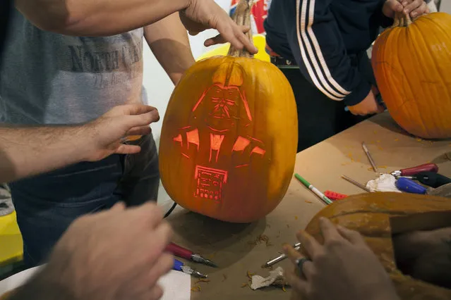 Light was inserted into a close to be finished Darth Vader pumpkin at Cotton Candy Machine in Brooklyn, N.Y. on October 18, 2014. (Photo by Siemond Chan/Yahoo Finance)