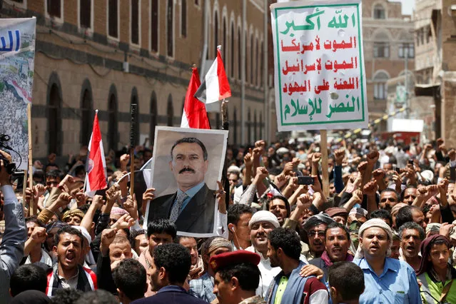 People hold a poster of Yemen's former president Ali Abdullah Saleh as they demonstrate outside a parliament session held for the first time since a civil war began almost two years ago, in Sanaa, Yemen August 13, 2016. The placard reads: “Allah is the greatest. Death to America, death to Israel, a curse on the Jews, victory to Islam”. (Photo by Khaled Abdullah/Reuters)