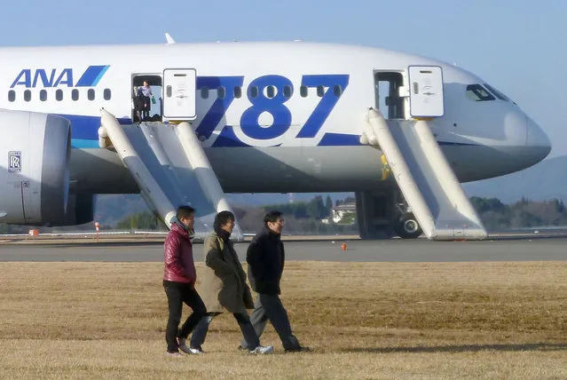 In this photo taken by a passenger and distributed by Japan's Kyodo News, passengers leave an All Nippon Airways Boeing 787 after it made an emergency landing at Takamatsu airport in Takamatsu, Kagawa Prefecture, western Japan, Wednesday, January 16, 2013. ANA said a cockpit message showed battery problems and a burning smell was detected in the cockpit and the cabin, forcing the 787 on a domestic flight to land at the airport. (Photo by AP Photo/Kyodo News)