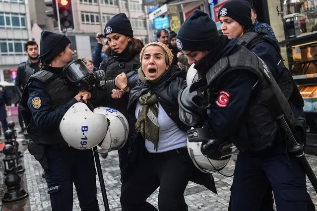 A woman reacts as Turkish anti-riot police officers arrest her during a demonstration called by Halklarin Demokratik Partisi (Peoples' Democratic Party – HDP) members to protest against Turkey's “Olive Branch” operation in Syria on January 21, 2018 at the Kadikoy district, in Istanbul. Turkey launched operation “Olive Branch” on January 20, 2018 seeking to oust from the Afrin region of northern Syria the Peoples' Protection Units (YPG) which Ankara considers a terror group. Operation “Olive Branch” is Turkey's second major incursion into Syria during the seven-year civil war. (Photo by Ozan Kose/AFP Photo)