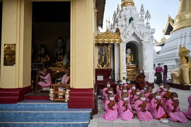 Young nuns pray at Shwedagon Pagoda during the Full Moon Day of warso, in Yangon on July 12, 2022. (Photo by AFP Photo/Stringer)
