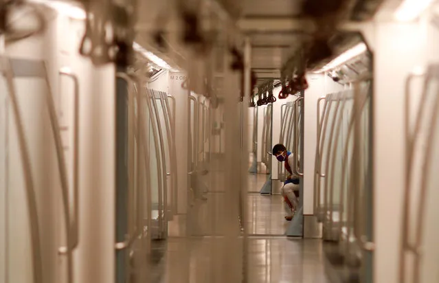 A man wearing a face mask travels inside a Delhi metro train, on the first day of the restart of their operations, amidst the spread of coronavirus disease (COVID-19), in New Delhi, India, September 7, 2020. (Photo by Adnan Abidi/Reuters)