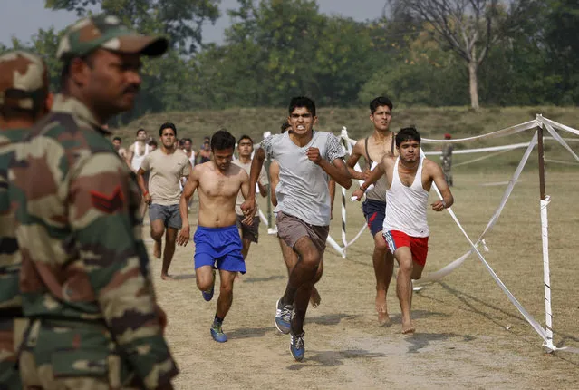 Candidates run during an Indian army recruitment rally at Sunjwan Military station on the outskirts of Jammu, India, Friday, October 30, 2015. (Photo by Channi Anand/AP Photo)