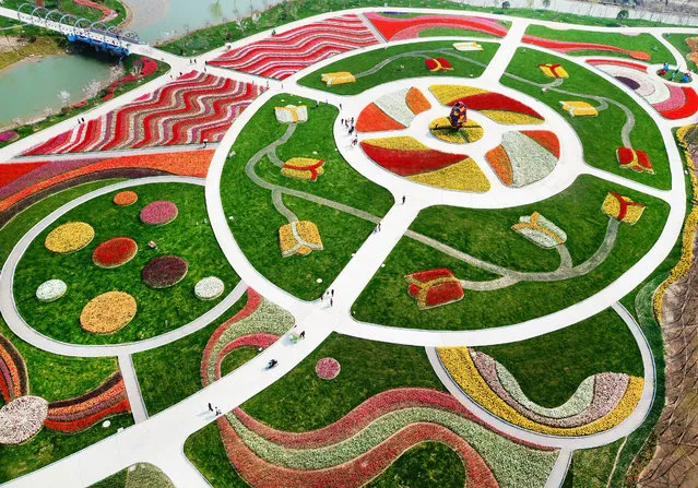 This photo taken on March 28, 2018 shows an aerial view of a park decorated with different coloured flowers in Nantong in China's Jiangsu province. (Photo by AFP Photo/Stringer)
