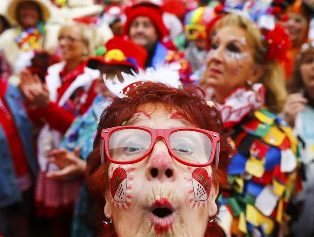 A carnival reveller celebrates the start of the carnival season in Cologne November 11, 2015. (Photo by Wolfgang Rattay/Reuters)