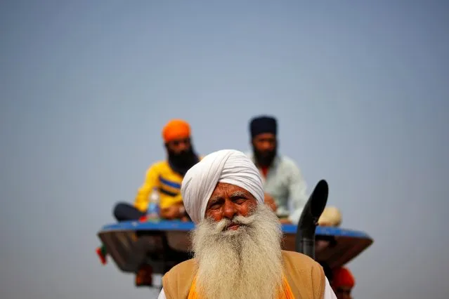 Farmers sit on a tractor during a protest against the newly passed farm bills at Singhu border near Delhi, India, December 5, 2020. (Photo by Adnan Abidi/Reuters)