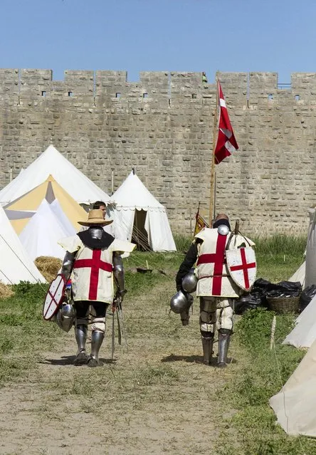 Members of UK team walk back to their camp during the “Battle of Nations” in Aigues-Mortes, southern France, Friday, May 10, 2013 where Middle Ages fans attend the historical medieval battle  competition. The championship will be attended by 22 national teams, which is twice the number it was last year. The battle lasts until May 12. (Photo by Philippe Farjon/AP Photo)