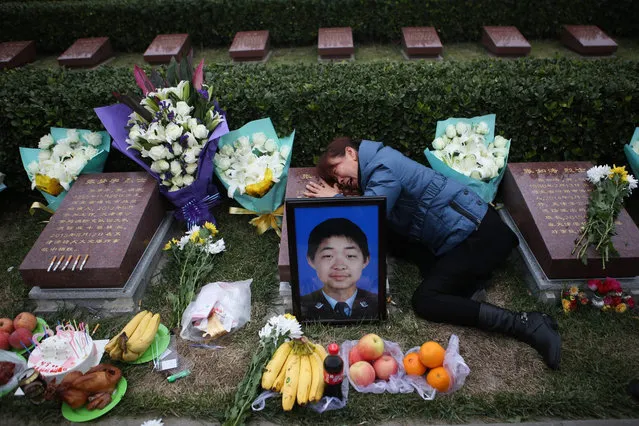 Mother of a fireman Zhang Qian who killed in the Tianjin chemical explosions accident,  grieves on her son's tombstone at the 100th days memorial  in a martyr's cemetery in Tianjin city, China, 19 November 2015. Explosions and a fireball at a chemical warehouse killed at least 165 people in the north-eastern Chinese port city of Tianjin late on 12 August. The magnitude of the initial blast was similar to three tons of TNT exploding and a second blast's magnitude was equivalent to 21 tons of TNT, China's earthquake bureau said. (Photo by EPA/Stringer)