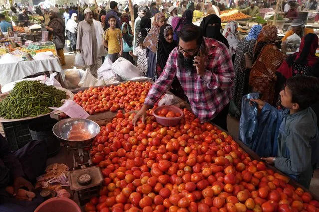 People shop for vegetables and other items at a bazaar, setup by provincial government to provide items on discounted rates, in Karachi, Pakistan, Wednesday, April 12, 2023. The International Monetary Fund has slashed the growth outlook for cash-strapped Pakistan, forecasting the South Asian country's fragile economy will grow just 0.5% this year, down from 6% in 2022. (Photo by Fareed Khan/AP Photo)