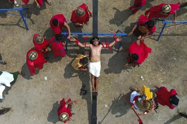 Ruben Enaje is nailed to the cross during a reenactment of Jesus Christ's sufferings as part of Good Friday rituals April 7, 2023, in the village of San Pedro, Cutud, Pampanga province, northern Philippines. The real-life crucifixions, a gory Good Friday tradition that is rejected by the Catholic church, resumes in this farming village after a three-year pause due to the coronavirus pandemic.(Photo by Aaron Favila/AP Photo)