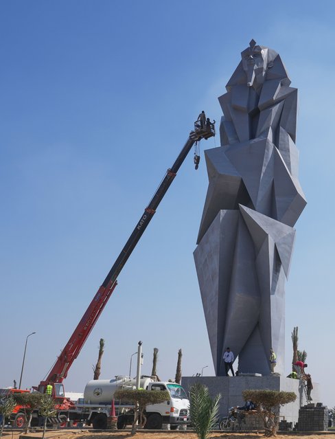 Workers paint the 27 meters (89 feet) iron statue “The guard” by Egyptian artist Deyaa Awed, which will face visitors coming from Sphinx airport to the Grand Egyptian Museum in Giza, Egypt, Tuesday, October 28, 2025. (Photo by Amr Nabil/AP Photo)
